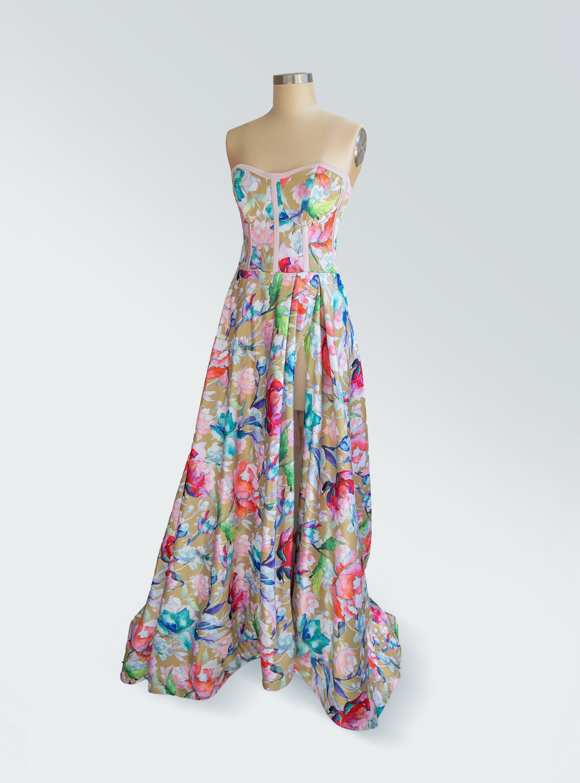 Colorful floral dress on a mannequin against a white background
