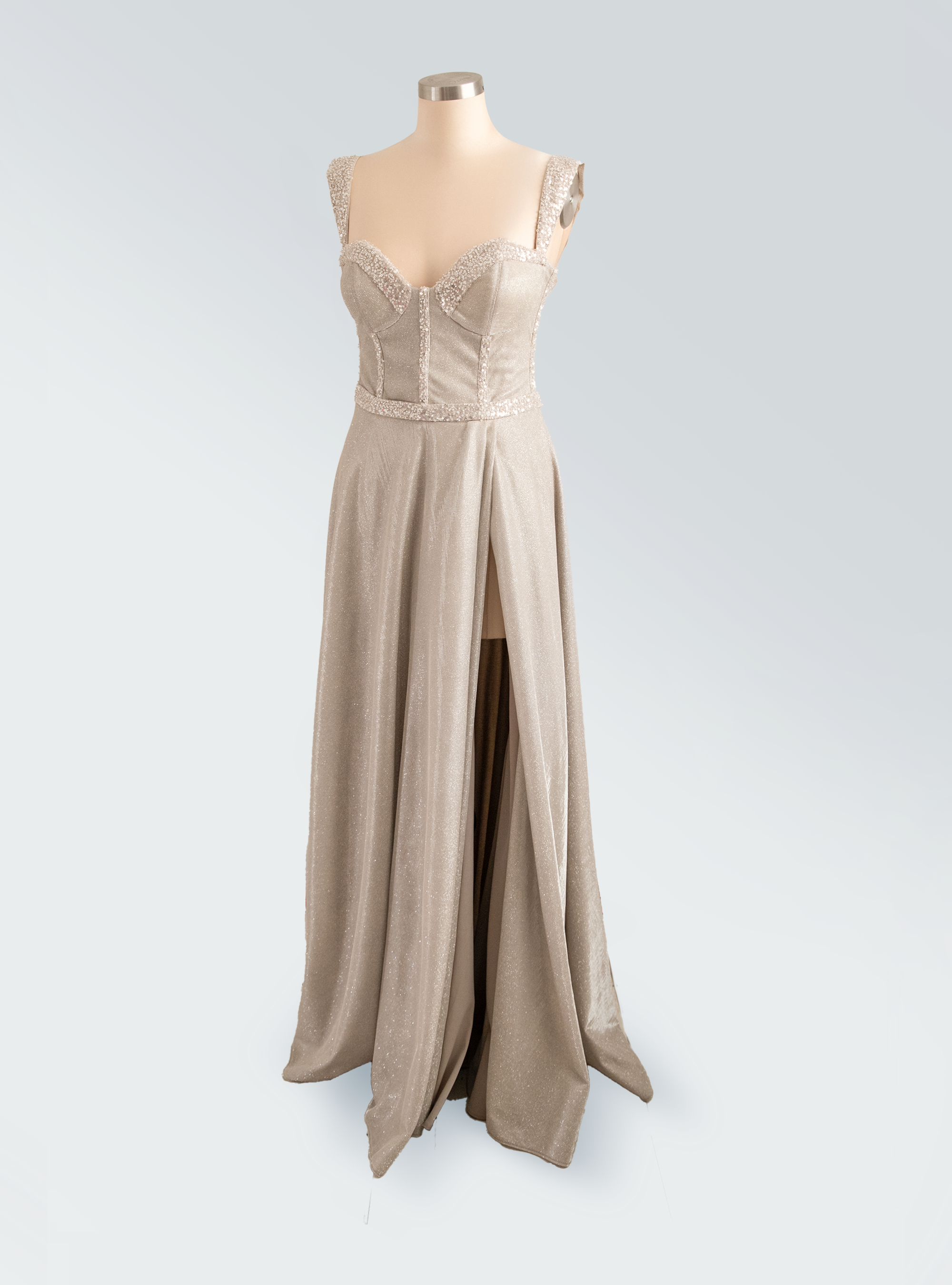 Beige evening gown on a mannequin against a light gray background